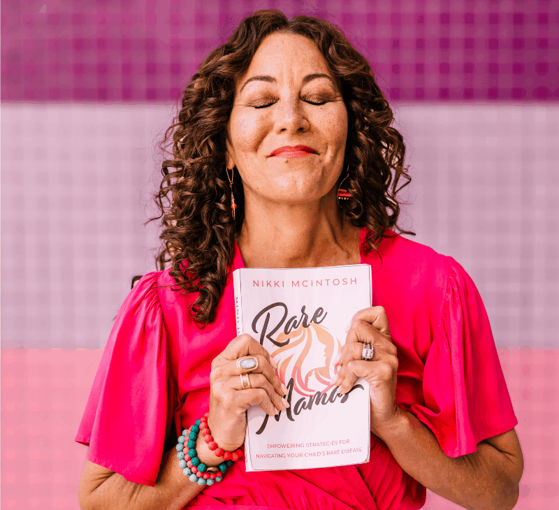 Nikki McIntosh holds the book Rare Mamas to her heart.